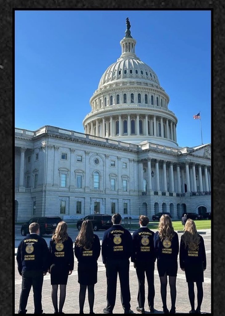 Wyoming members stand facing the capitol building in Washington, D.C.