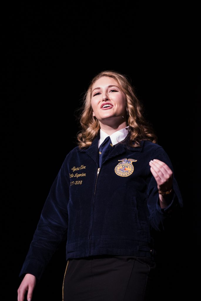Girl in FFA Jacket delivers a speech