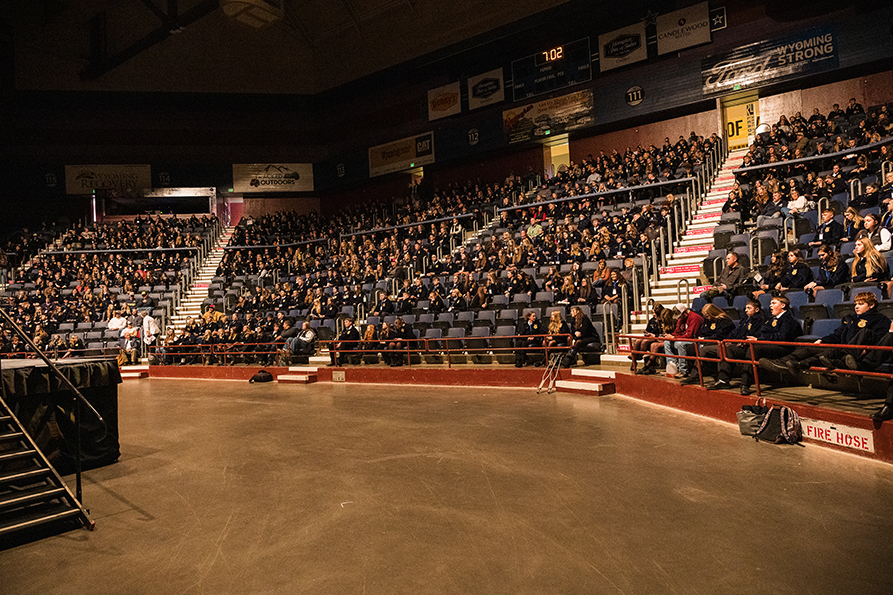 FFA members fill the stands at a large indoor arena during a state conference session.