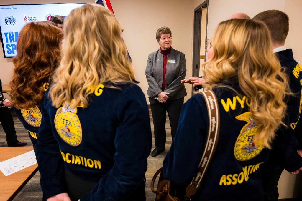 Wyoming FFA officers visit with a state legislator during CTE Month advocacy visits at the Wyoming State Capitol.