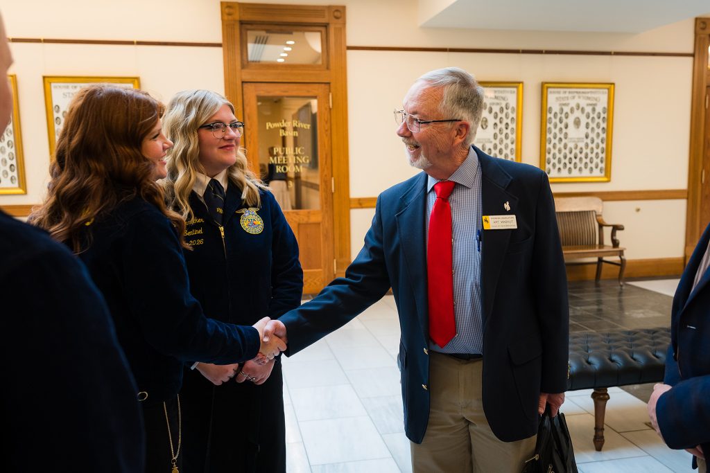 A Wyoming FFA member greets a state legislator during CTE Month advocacy visits at the Wyoming State Capitol.