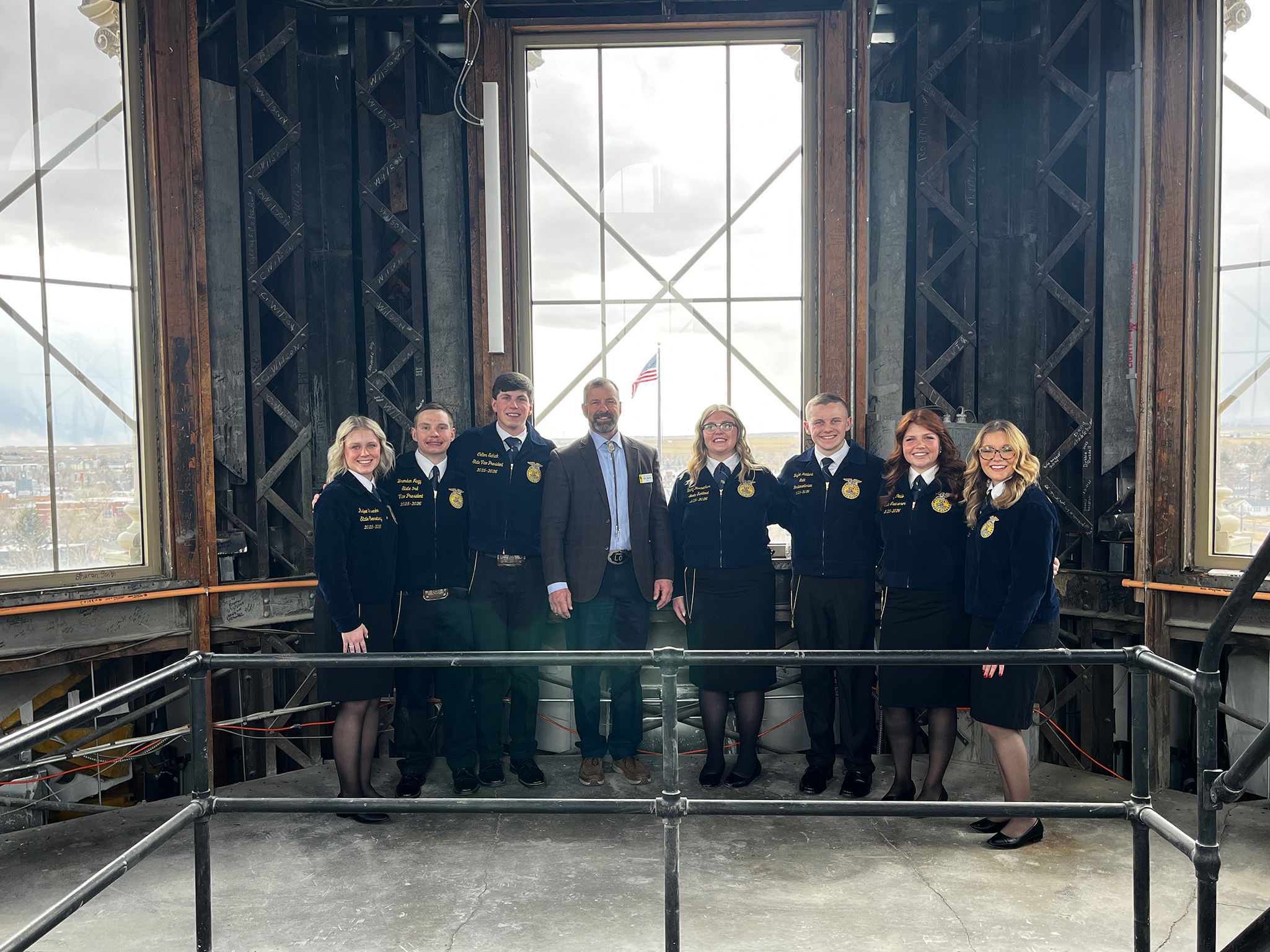 Wyoming FFA state officers pose with a state official inside the Wyoming State Capitol building.