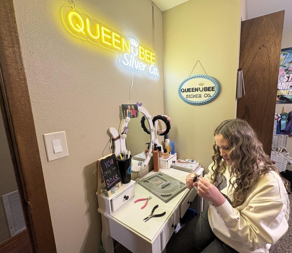 A high school student works on a piece of jewelry