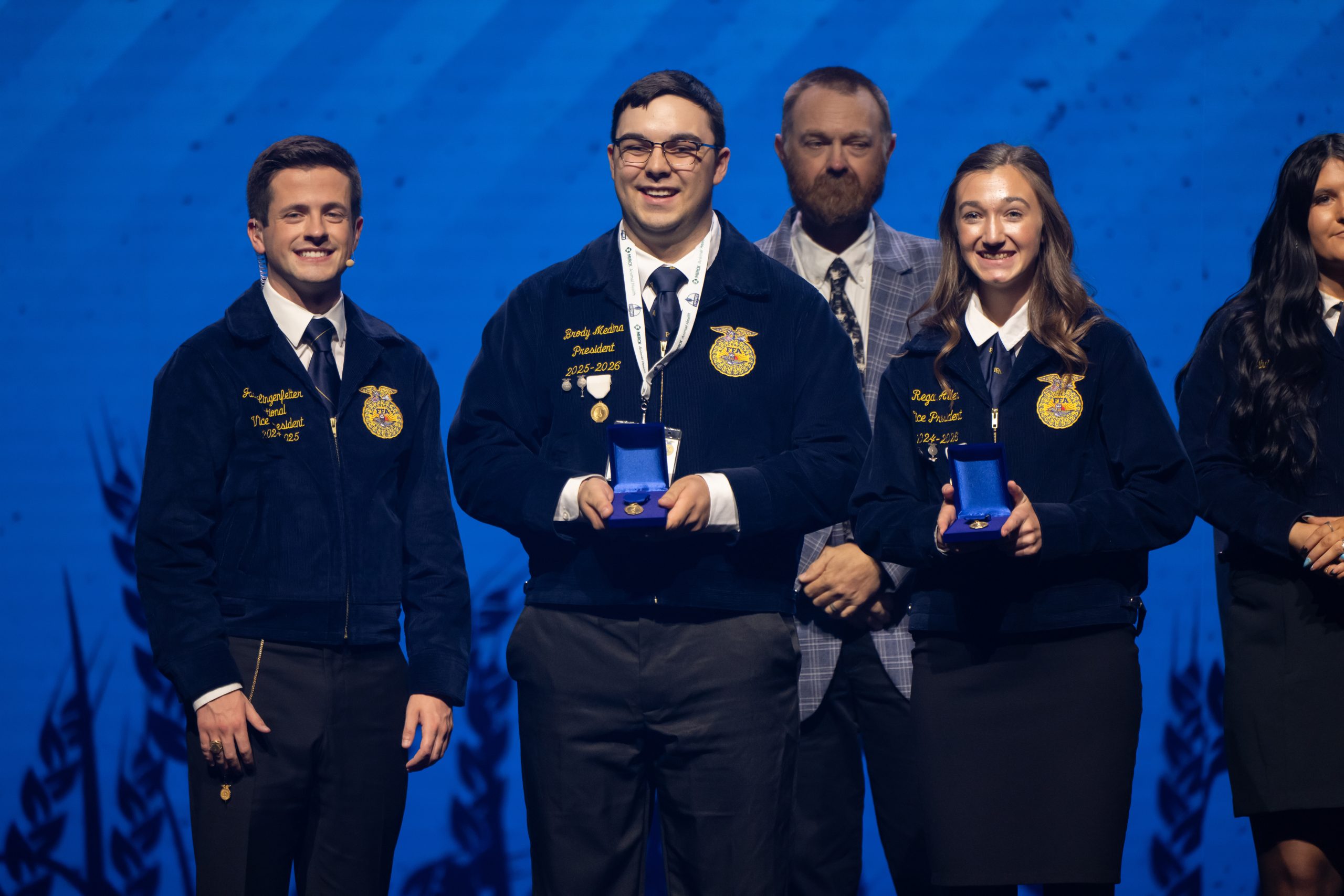 Wyoming FFA members hold awards for Agriscience Fair on the national FFA convention stage.